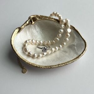 Handmade clam shell ring dish. Gold trim with pearl white inside.